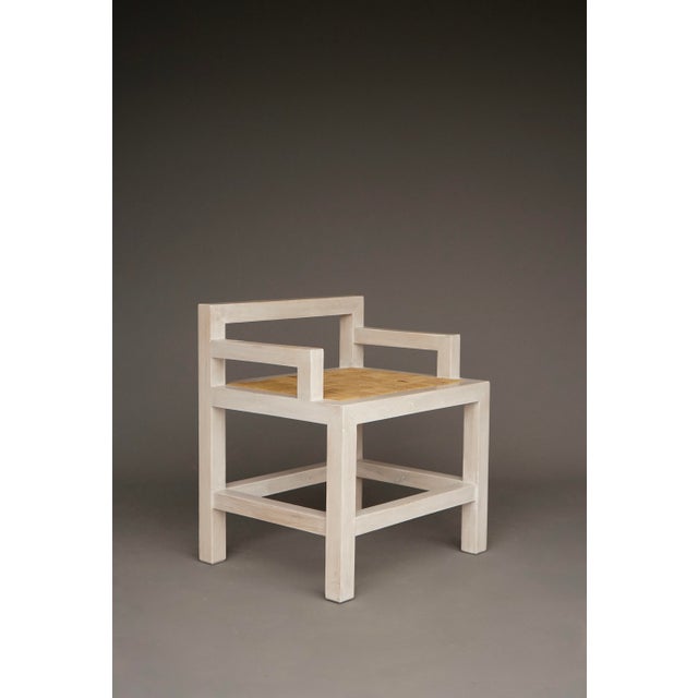 A modernist side chair. The surface is painted with a semi-transparent lacquer. The drop-in seat has fabric straps.