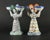 A great pair of somehow whimsical French faience double salts Each shaped as a two faced woman in Breton attire, caring a...