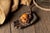 Carved figural pipe depicting a skull cradled in an outstretched hand, paired with a matching sculpted hand tray. Executed...