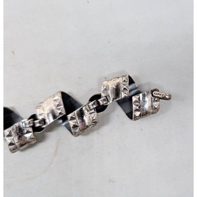1950s silvertone scrolls with studs along the edges links with round domed spacers bracelet with spring ring clasp. Marked...