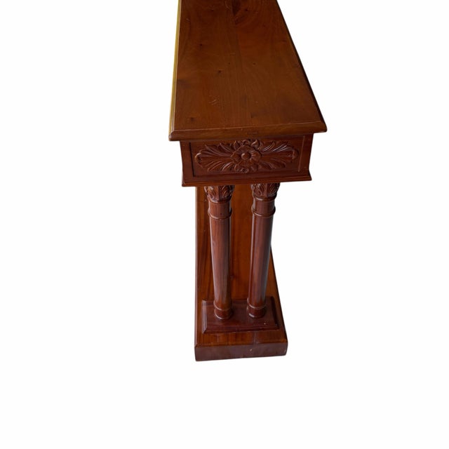 The console table is a Neoclassical-style mahogany console table, featuring a Greek key carved design. This style is...