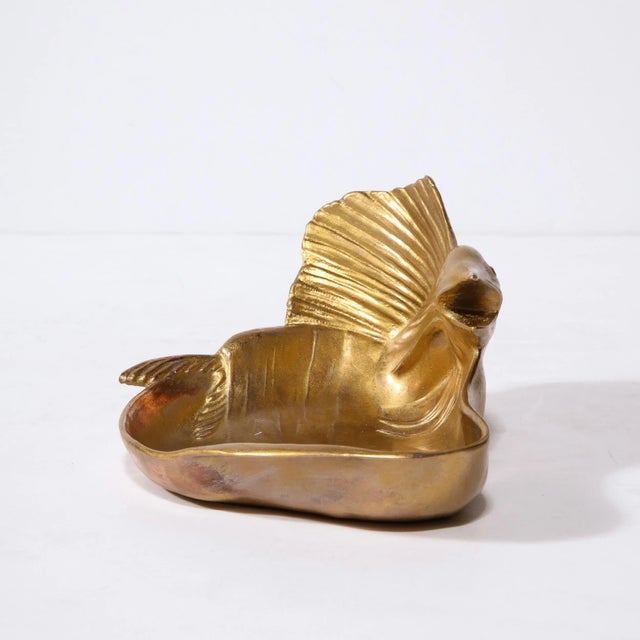 This sculptural modernist gilded dish was realized in the United States circa 1980. It features an amorphic and...