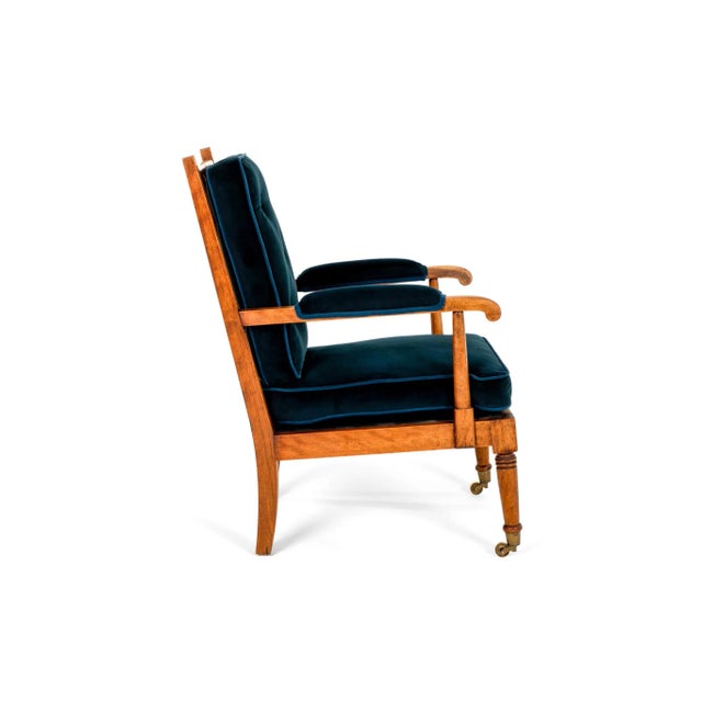 A Victorian Show Frame armchair in mahogany with navy blue squab cushions to the seat and backrest. The square tapering...