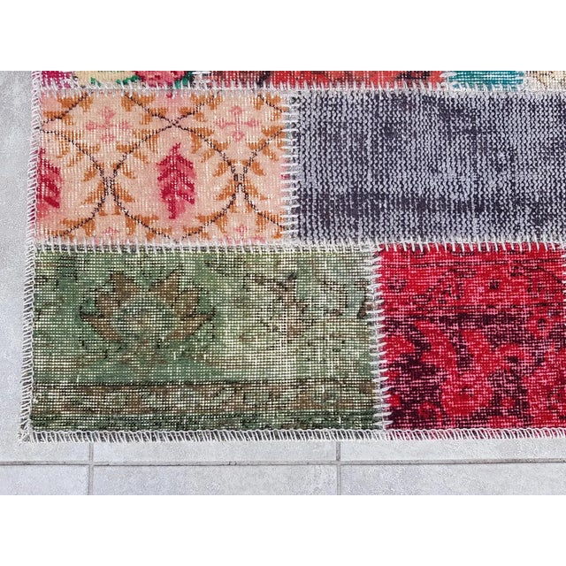 This is a vintage Turkish Oushak rug from the Mid 20th Century. The piece was hand-knotted.