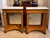 Empire-style pair of consoles with burlwood surfaces and white marble tops. Each console has a single drawer with visible...