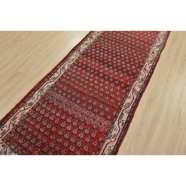 An authentic vintage tribal Mir runner hand-knotted with fine wool and natural dyes. This nomadic oriental rug features an...