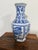 “Vintage blue‑and‑white ceramic vase with a hexagonal form and hand‑painted floral motifs. Heavier ceramic body with a...