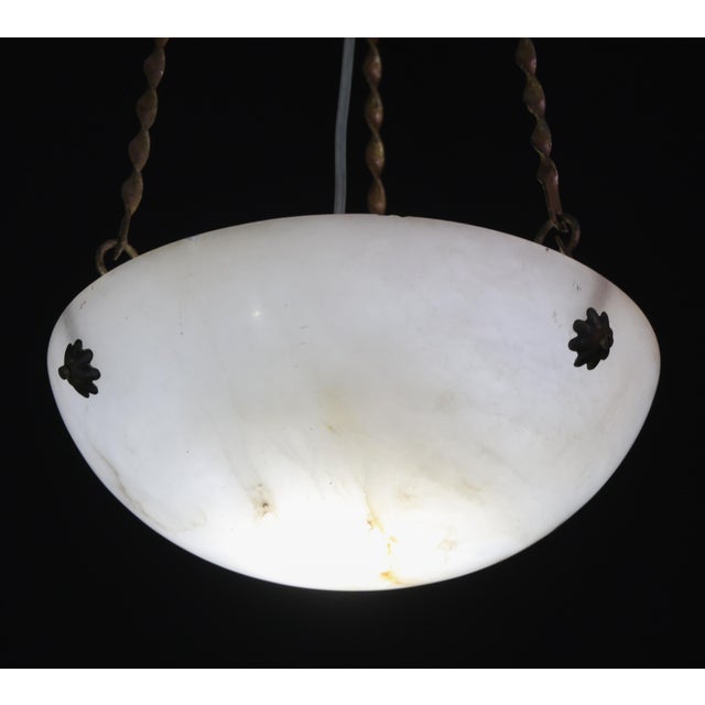 Elegant French Art Deco pendant lamp featuring richly veined alabaster. This elegant French Art Deco pendant lamp dates...