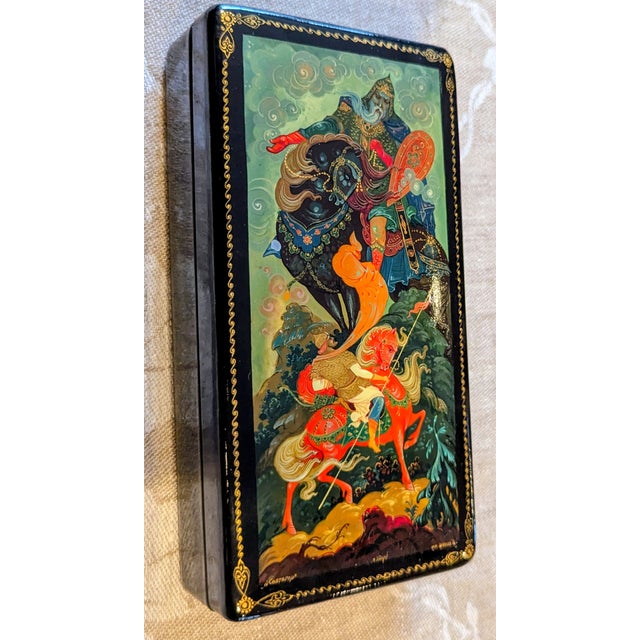 This hand-painted lacquer box depicts one of the most famous legends from the Byliny (East Slavic oral epic poems). The...