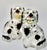 A charming and unusual pair of antique English Staffordshire spaniels, each seated upright and holding a flower filled...