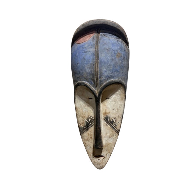 Superb vintage Fang mask carved from a single piece of heavy wood, featuring an elongated heart-shaped face rendered in...