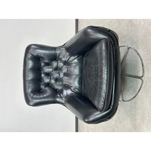 Black leather swivel wingchair by PeeM in very nice original condition with signs of use. This piece is attributed to the...
