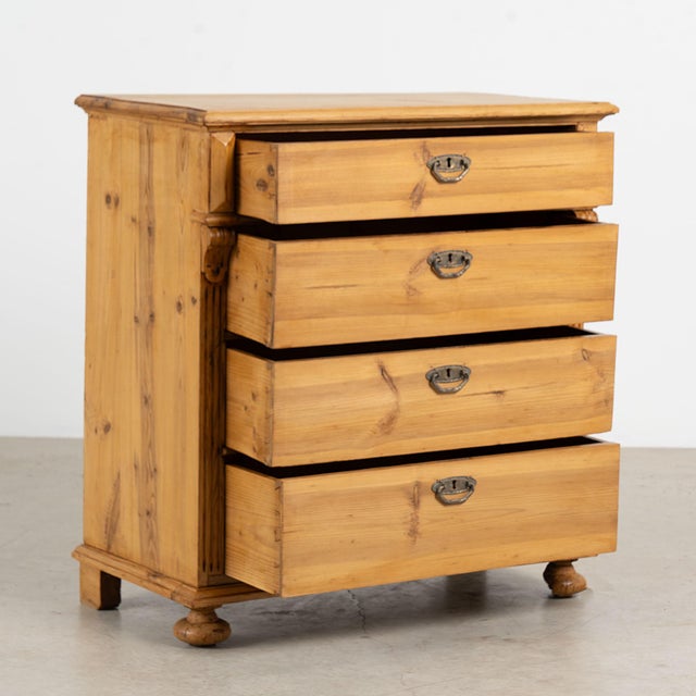 19th century Danish chest of four drawers, crafted in pine with a warm waxed finish that enhances the natural color and...