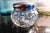 A round antique cut glass dresser/vanity jar in the American Brilliant Period style (roughly 1900s–1920s), with deep-cut...