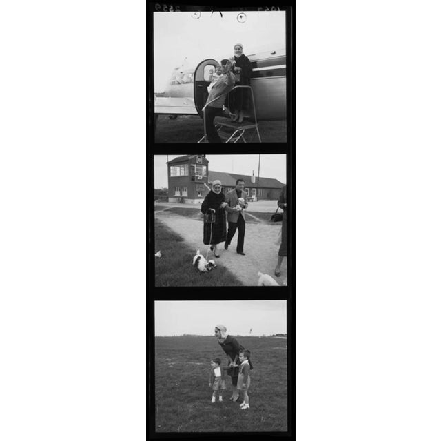 "Taylor, Todd And Family" by Stanley Sherman A young woman modelling an outfit consisting of a three-quarter-length dress,...