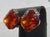 Faux Maderia Topaz faceted crystal in gold-plated metal clip-ons. Rhinestone-edged center stone. The measurements are...