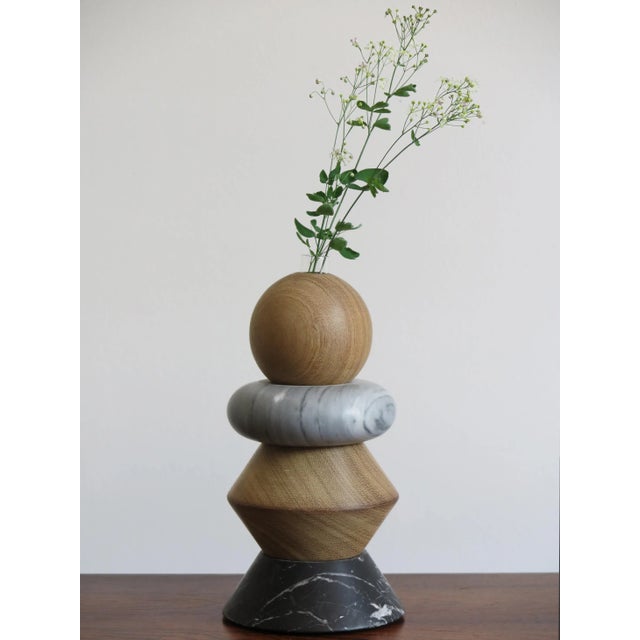 This candle or flower holder is composed of 2 marbles: Carrara White and Bardiglio Gray, and solid wood. It features an...
