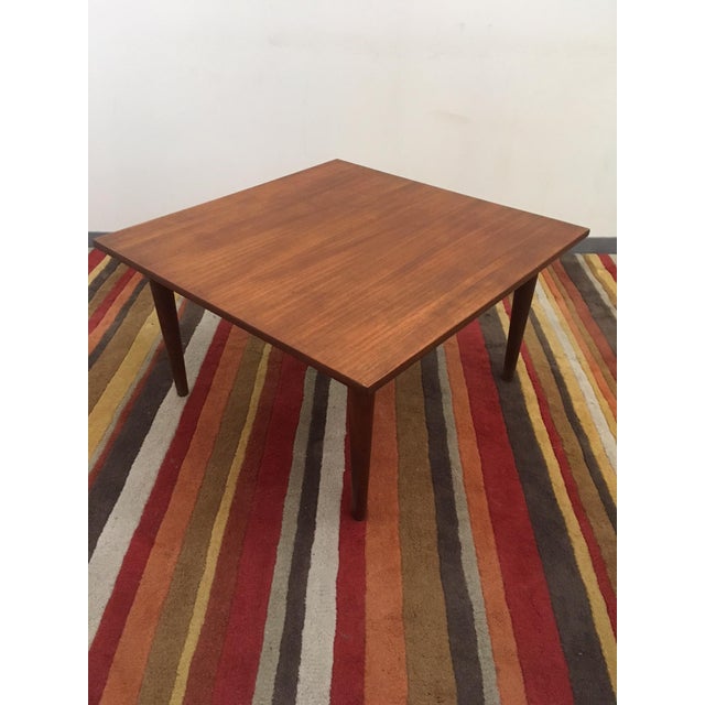This side or end table is made of teak. It features a square shaped tray, round fasteners and removable legs. This table...