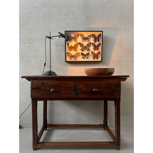 Antique Spanish side table. Colonial. Solid wood with visible hand-carved and planed markings. This contributes to the...