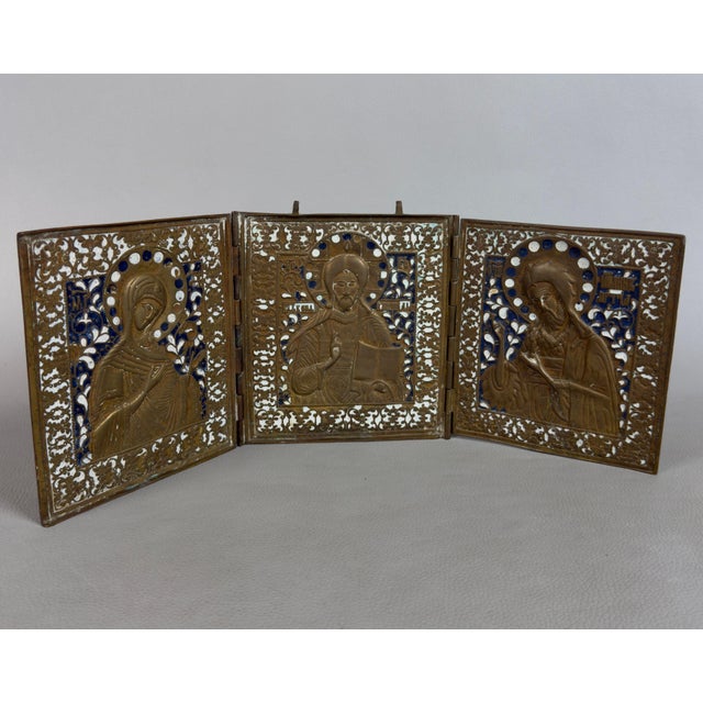 A precious and rare devotional travel triptych in finely chiseled brass and glass enamel, complete with a acrylic glass...