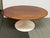Design Plus Gallery presents a Tulip Base Coffee Table. The two tone coffee table has a walnut wood oval surface with a...
