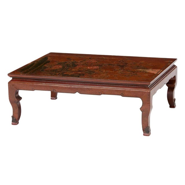 This Chinese coromandel style coffee table features a hand-painted lacquered top with intricate floral and landscape...