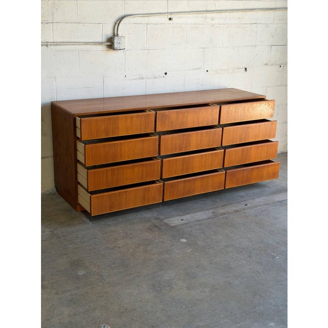 This lowboy presents a sleek profile with twelve flush storage compartments. Clean horizontal lines are supported by a...