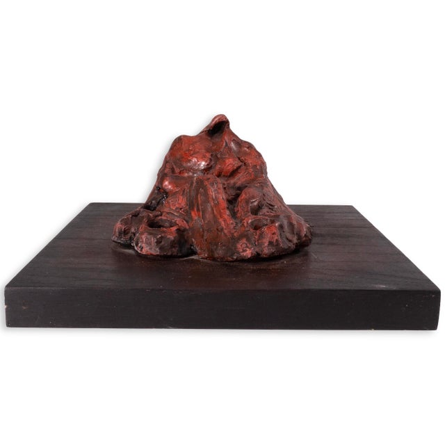 This untitled 1996 work by Richard Kozlow is a cast bronze sculpture finished in a rich red patina, mounted on a dark wood...