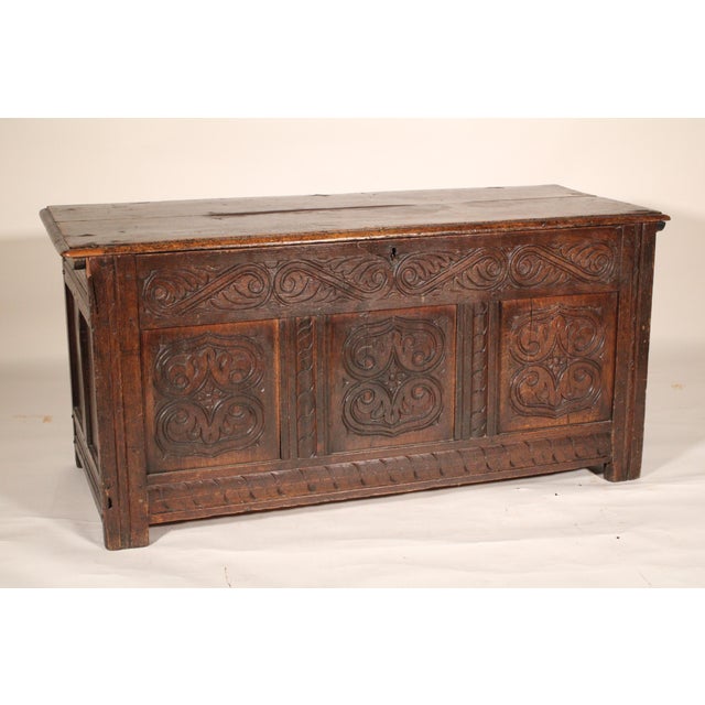 English oak Tudor style trunk, 18th century. With a two board rectangular top with molded front and side edges, the front...