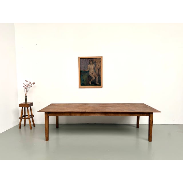 Maison Lecan presents this extra-large farmhouse table in solid oak, a product of French rural production from the 1950s....