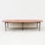 An outstanding expandable dining table in mahogany and brass with ebonized accents from Paul McCobb's Connoisseur...
