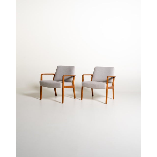 Oak frame with contoured armrests, padded seat and backrest upholstered in a light gray cotton blend. Scandinavian...