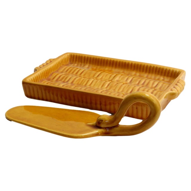 This charming piece, with its warm mustard glaze and intricate embossed detail, adds a touch of Provence to any table....