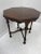 Antique flame mahogany accent table with Burl accents and hand carved details.