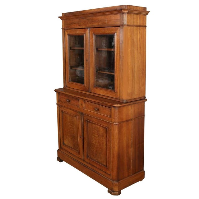 This elegant 19th century French walnut buffet features a classic two-part design with an upper cabinet and a paneled...