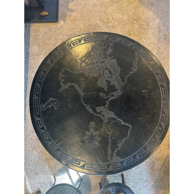 This is a rare, limited-edition artisan furniture set consisting of one circular, hand-tooled leather table and four...