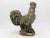 This iconic French Country rooster sculpture, fashioned from aged concrete, exudes rustic elegance and timeless allure....