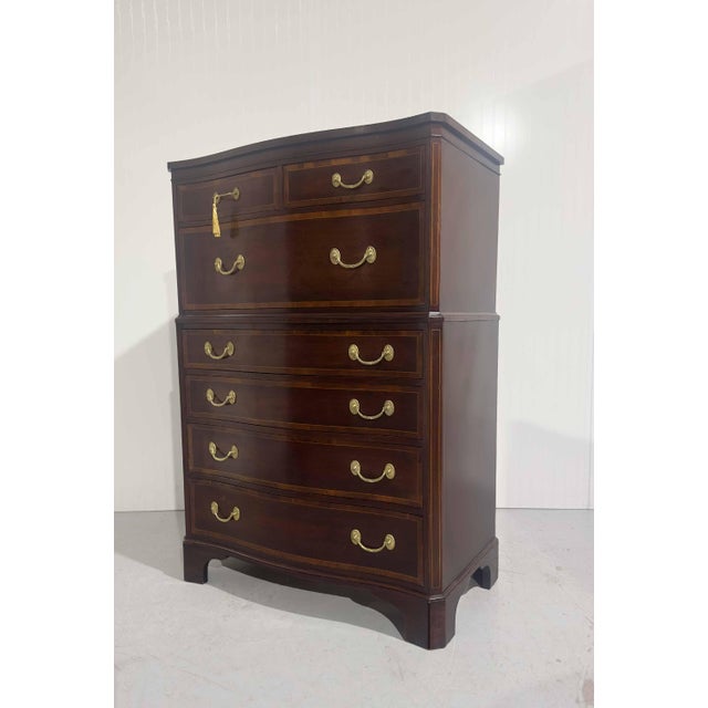 PRODUCT DESCRIPTION We have a handsome 1960s Georgian Banded Mahogany Highboy Dresser by Kindel of Grand Rapids, MI. This...