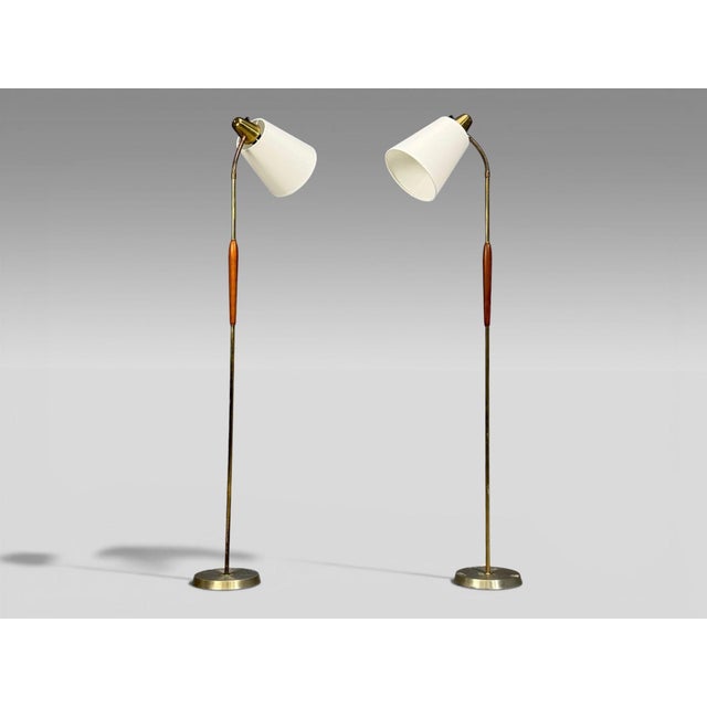 Swedish Mid-Century Modern, Pair of Floor Lamps, Teak, Brass, Sweden, 1940s Pair of adjustable floor lamps designed and...