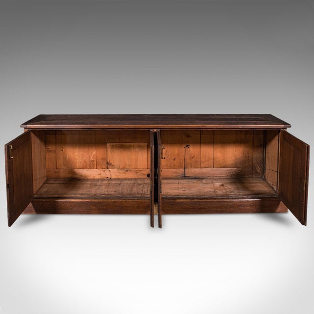 This is a large antique dresser base. An English, oak Gothic revival ecclesiastical cabinet, dating to the Victorian...