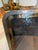 A vintage picture frame with rounded corners and overlapping silver and brass tone bands. The layered design gives this...