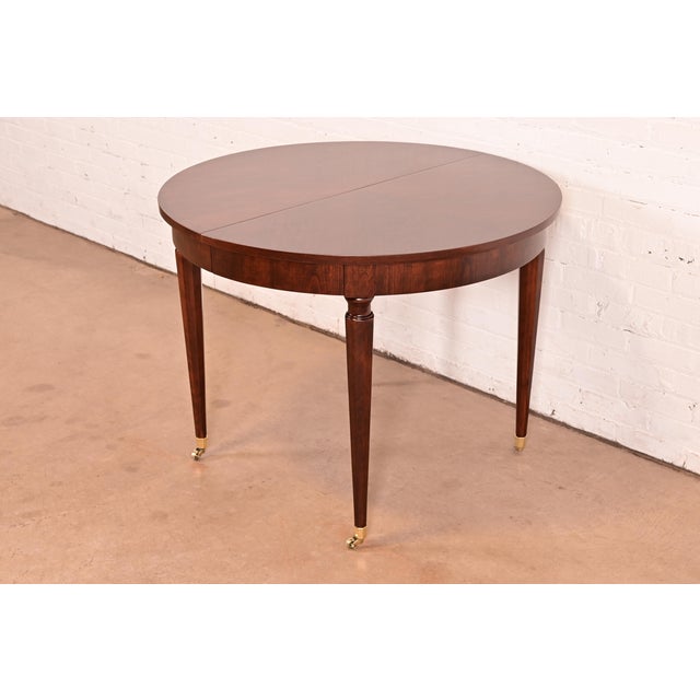 An exceptional French Regency Louis XVI style extension dining table By Kindel Furniture USA, Circa 1960s Gorgeous book-...