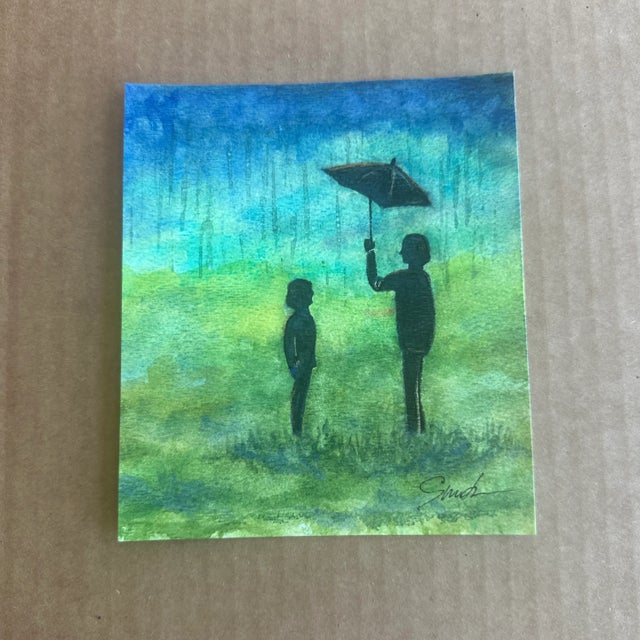 Immerse yourself in the poignant beauty of this heartfelt watercolor piece depicting two silhouetted figures standing...