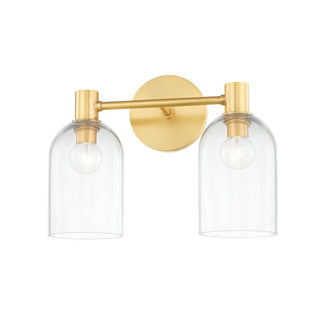 Drawing inspiration from antique glass bottles, a cloche-like shade in clear glass showcases a single bulb nested at the...