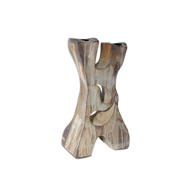 A studio pottery sculpture vase. This sculpturalvase is shaped like an "X" with two separate chambers at the top. The...