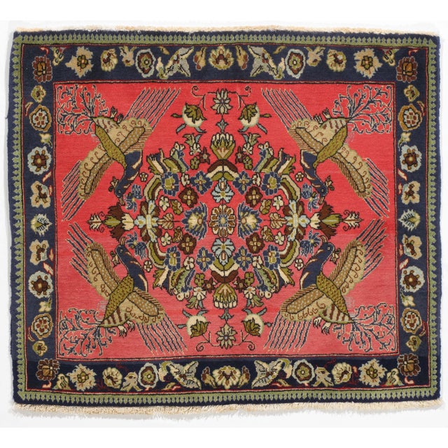 Vintage hand-knotted Persian Qom wool rug on a silk foundation, featuring a coral field with a central floral medallion...