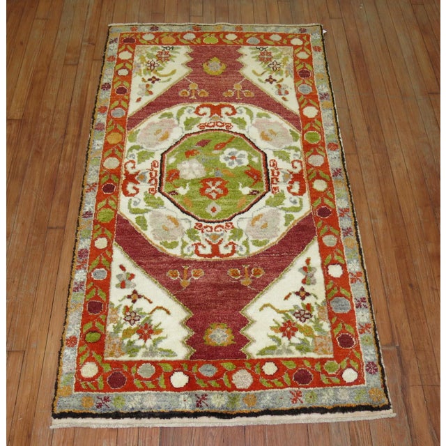 A mid 20th-century small throw-size Turkish rug. This piece is a true antique, one-of-a-kind rug that has been...