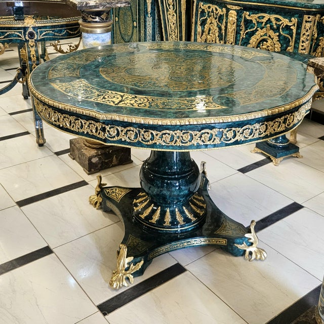 Make a striking statement with this magnificent French-inspired round table, featuring a rich deep green finish...