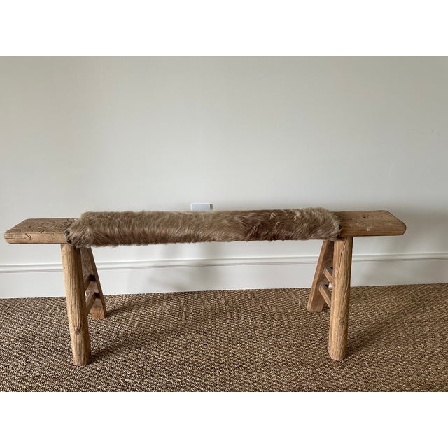 Antique rustic bench from Shandong province, China, crafted in solid elm wood, circa late 19th–early 20th century. The...