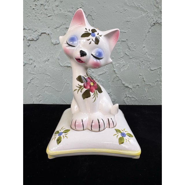 Charming and highly collectible, this 1960s Enesco salt and pepper shaker set features an adorable mid-century ceramic cat...